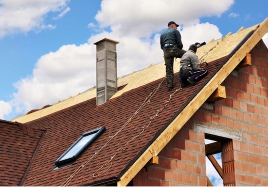 Asphalt shingle replacement near me by Silverline Roofing Limited, showing professional roofers installing durable shingles on a residential slope roof.